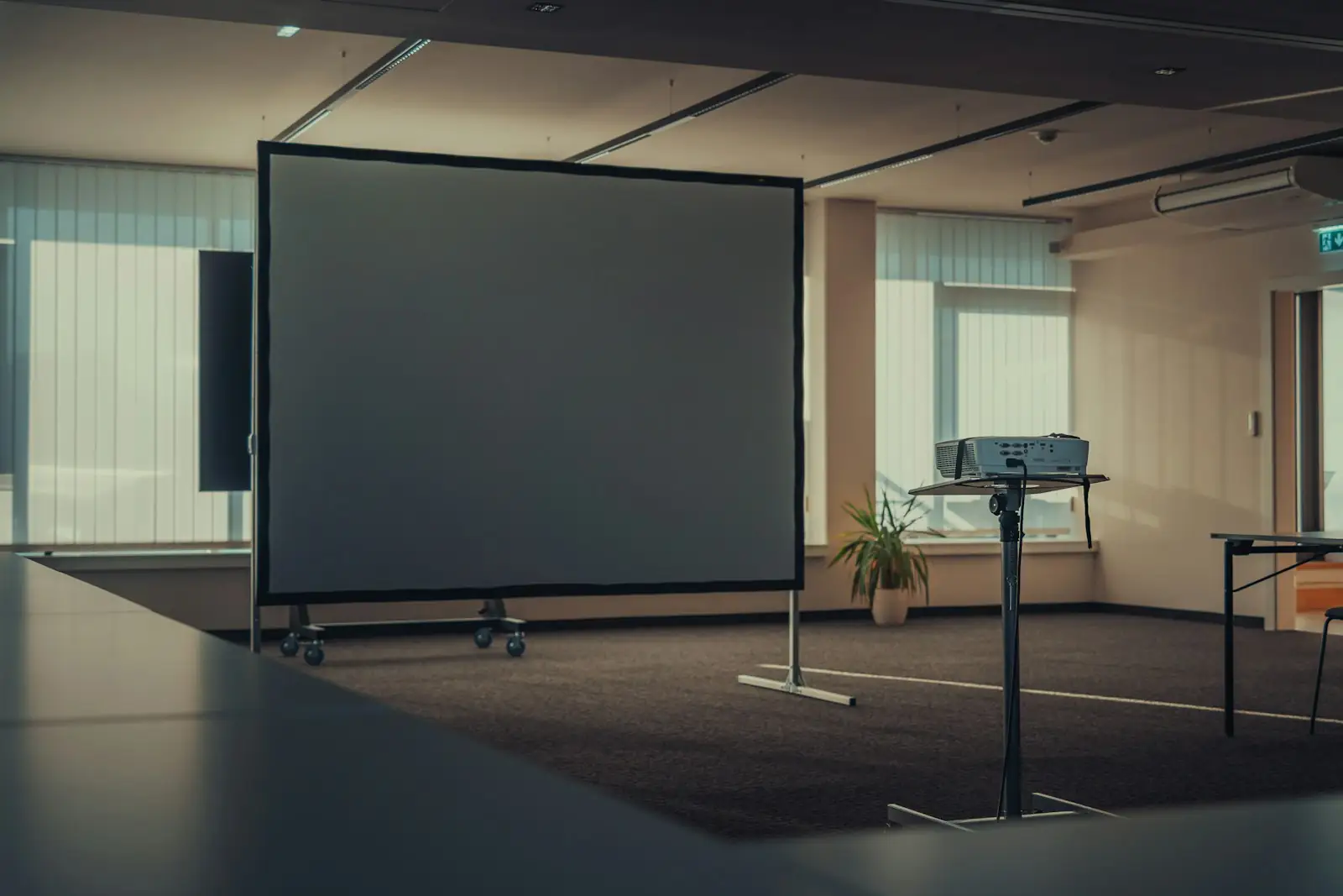 Large display screen at the front of an empty meeting room