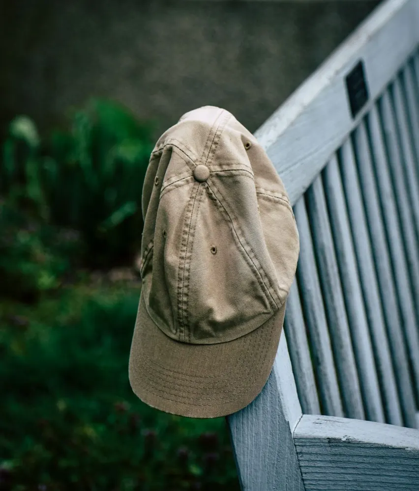 Beige cotton cap hanging on a bench