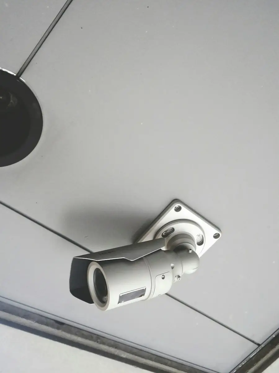Bullet security camera mounted on a white ceiling