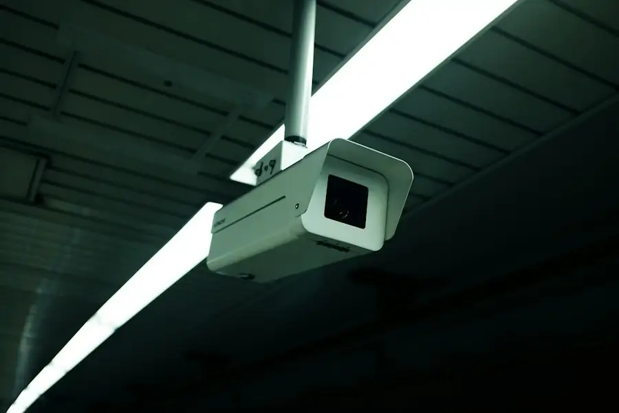 Security camera mounted on a ceiling in a dark building