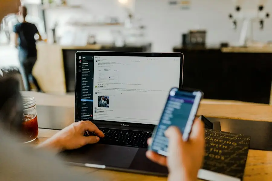 Person using a laptop and phone together