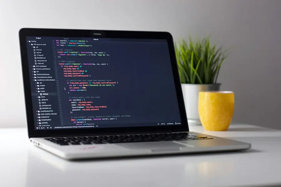 Laptop showing code on a white desk