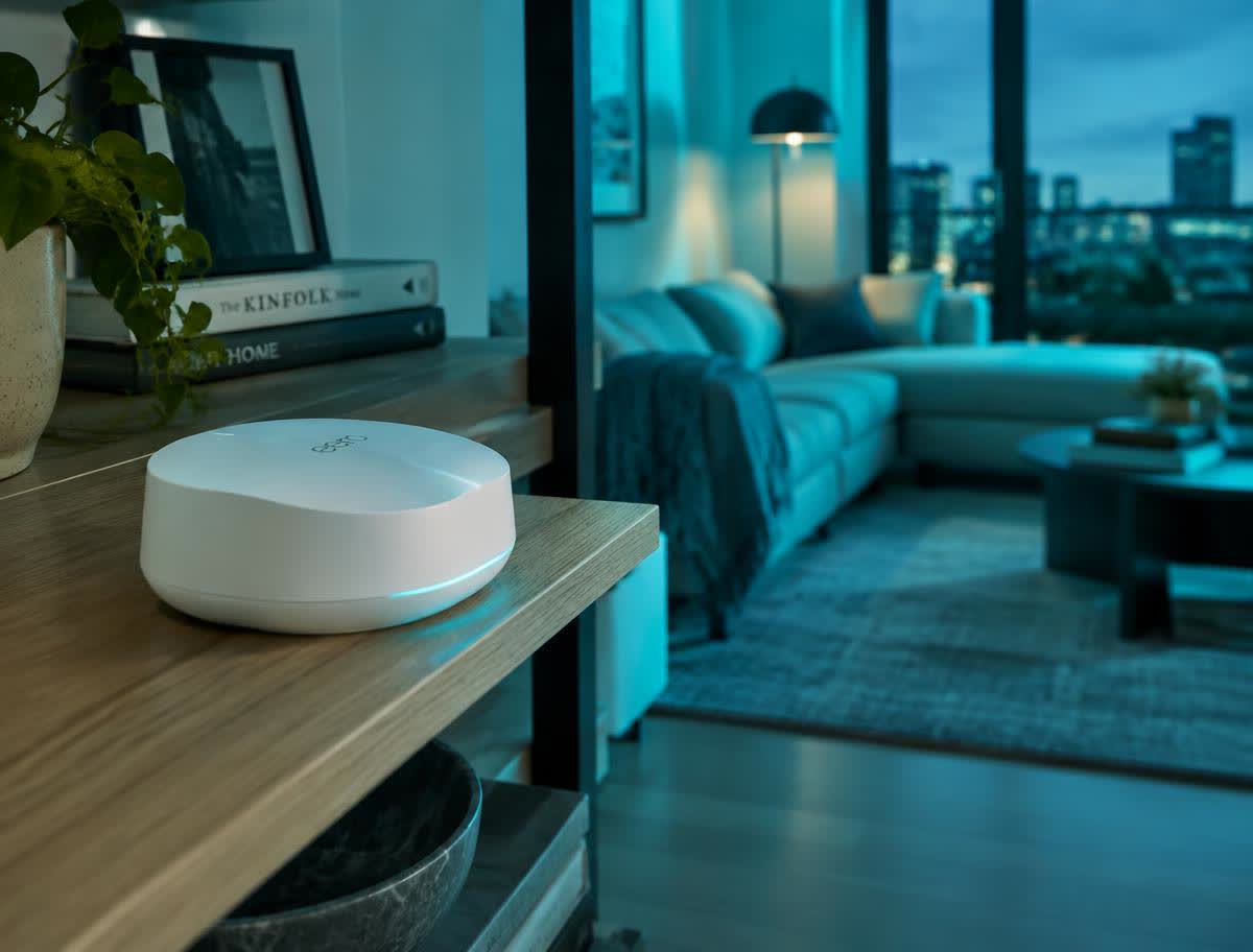 Mesh Wi-Fi unit on a shelf in a modern living room